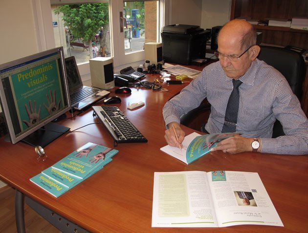 Manuel Roure en el seu estudi, amb la publicació Predominis visuals.