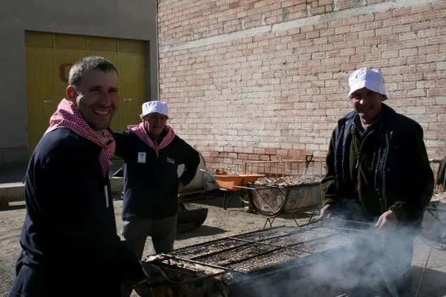 Els veïns del Poal preparen la carn per al dinar popular.