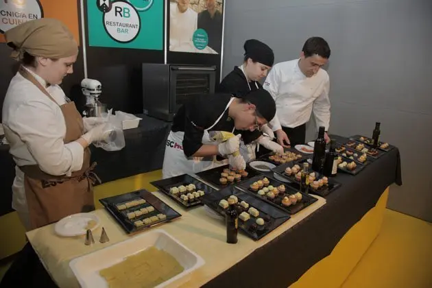 Alumnes de l&#39;Escola d&#39;Hoteleria preparen aperitius pel públic, a la Fira de L&#39;Oli.