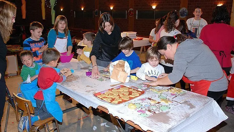 Les monitores ensenyen a elaborar les galetes als infants a Sidamon