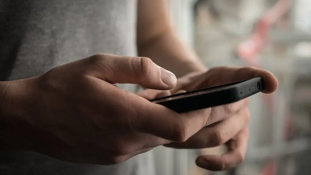 Close up of a man using mobile smart phone