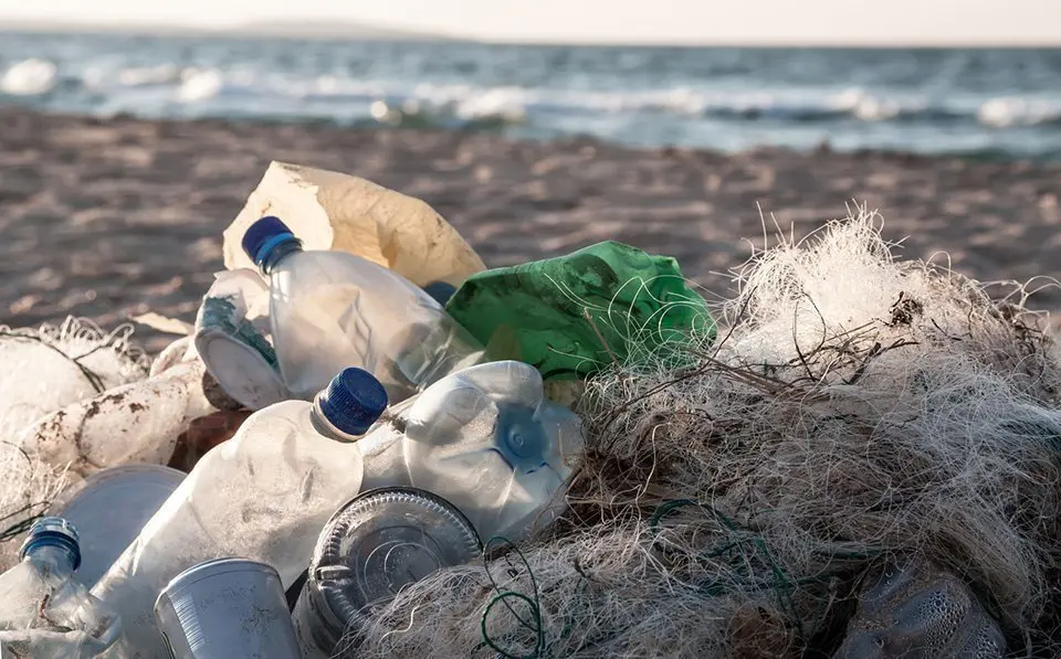 Beach pollution. Plastic bottles and other trash on sea beach