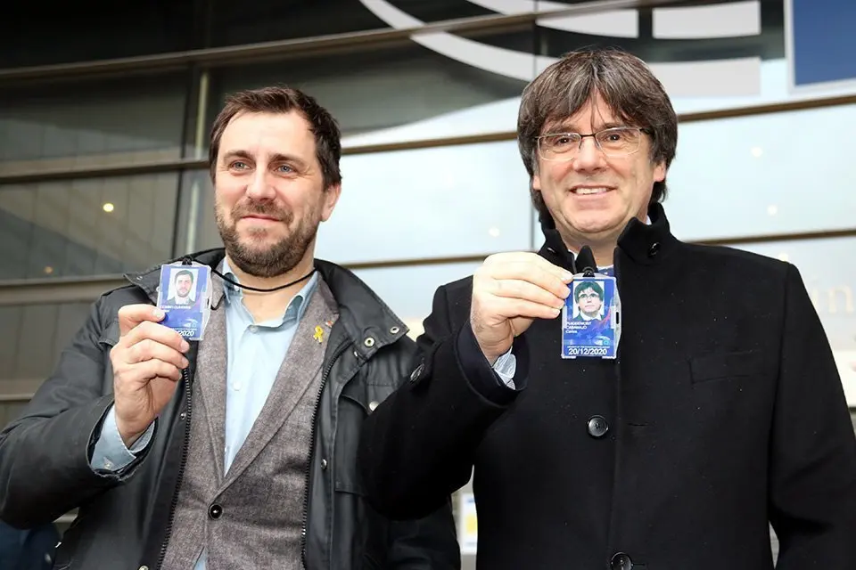 Pla mitjà de Carles Puigdemont i Toni Comín davant el Parlament Europeu a Brussel·les amb l'acreditació com a eurodiputats a la mà, el 20 de desembre del 2019. (Horitzontal)