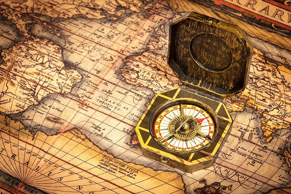 Vintage pirate retro compass on ancient world map