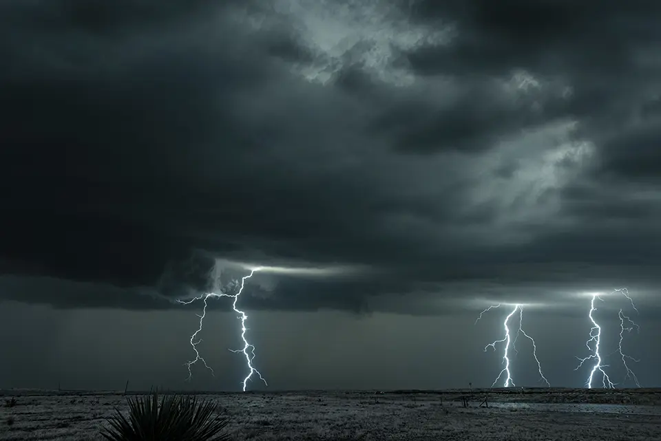 A mezocyclone lightning storm with dark clouds forming over the plains in Tornado Alley, Oklahoma at night

