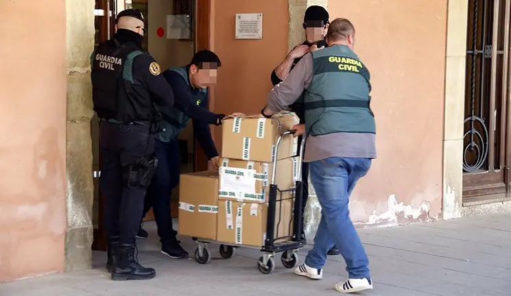 Agents de la Guàrdia Civil traient caixes de documentació de l'Ajuntament d'Almacelles