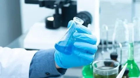 person-holding-laboratory-flask-2280571-1