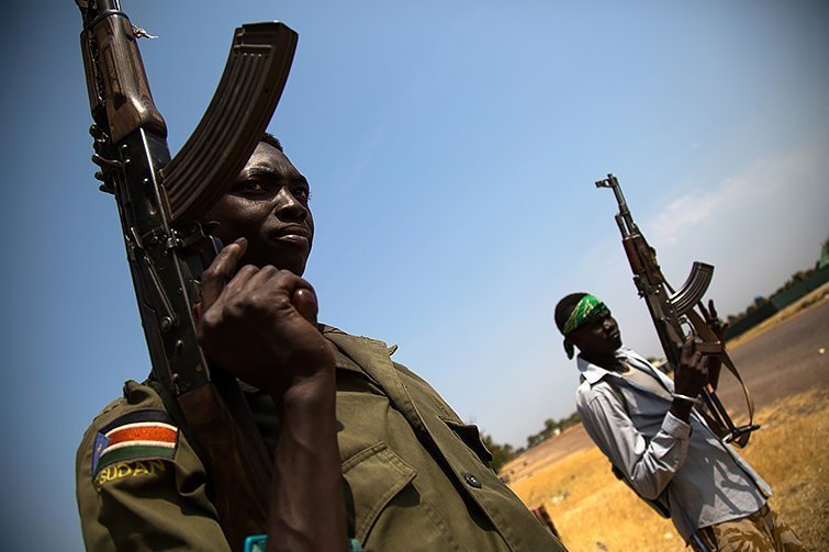 3 February 2016. Leer: Members of the South Sudanese army patrol the half-emptied village of Leer, South Sudan. A large part of the civilian population fled the village due to the fighting between Army forces and the Sudan People's Liberation Movement in Opposition (SPLM-IO) on October 2, 2015. Government forces pushed the rebels out but the clashes were followed with intensive looting by armed men who entered the all humanitarian compounds and stole equipment, medical supplies and money. The humanitarian personnel were evacuated and didn't regained access until December, but it's not fully operational yet. Photo by Albert Gonzalez Farran - AFP