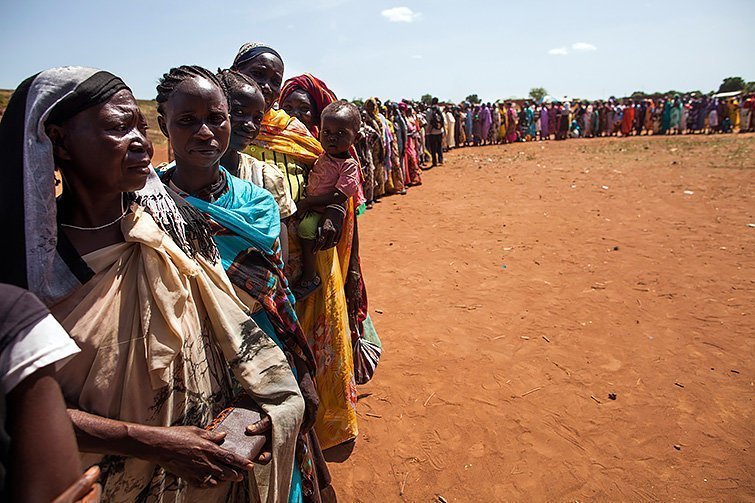 11 May 2016. Wau: Displaced people (IDP) recently arrived to Wau, South Sudan, due to armed clashes in surrounding villages wait to be registered by the International Organization for Migration (IOM) and the World Food Programme (WFP) on May 11, 2016. According to the Relief and Rehabilitation Commission of the South Sudanese Government, Wau has experienced the arrival of more than 95,000 new IDPs in the past six months due to these clashes between cattle keeps and agriculturalists, with Government and rebel forces also involved. This massive arrival of IDPs made this city highly overwhelmed with urgent need of extra services on health, food, water and sanitation. The prices in the market became higher and the rate of malnutrition increased three times in the past months. According to UNICEF, more than 30% of children in Wau currently suffer malnutrition, when the city used to have the lowest rate in the country, around 10%.Photo by Albert Gonzalez Farran - AFP