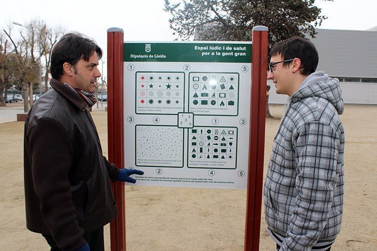 Jaume Folguera, regidor, i Hèctor Carrión, graduat en Ciències d’Activitat Física, amb el plafó del Nou Espai Lúdic i Salut de Tàrrega