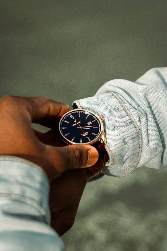 person-holding-analog-watch-3130646